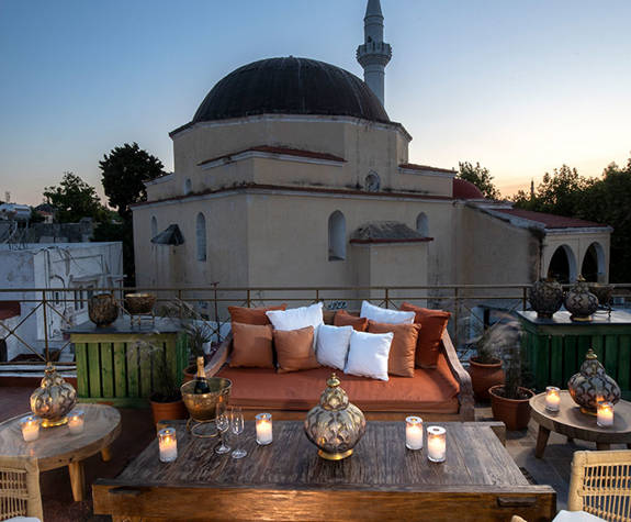 Decan Concept Boutique Estate Hotel Rhodes rooftop with a mosque in the background